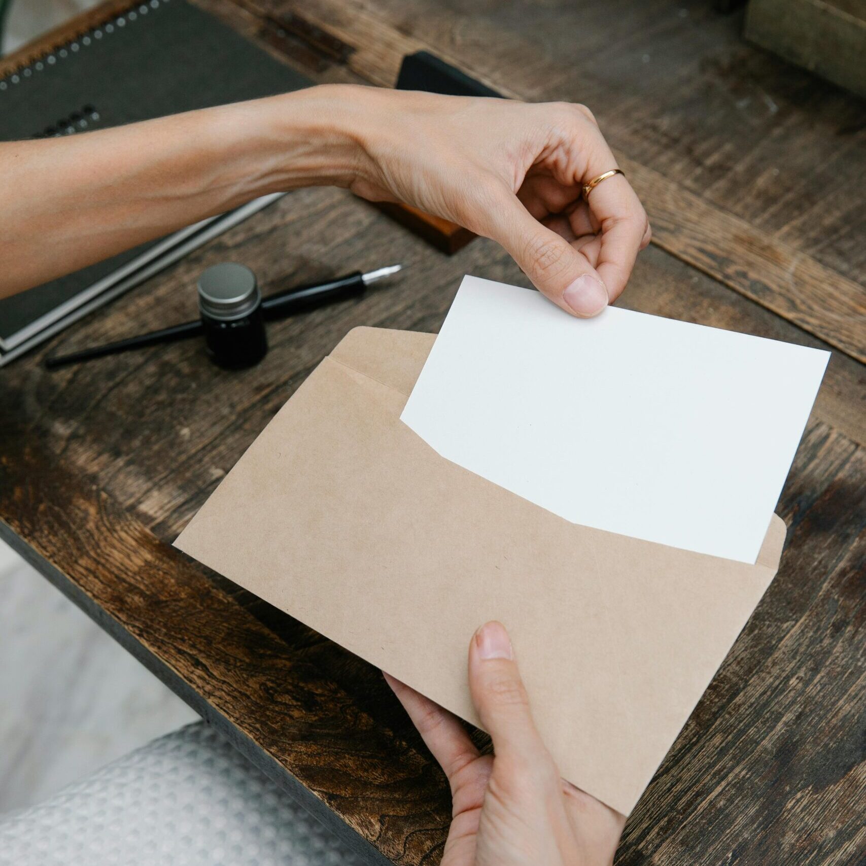 person holding a letter and envelop