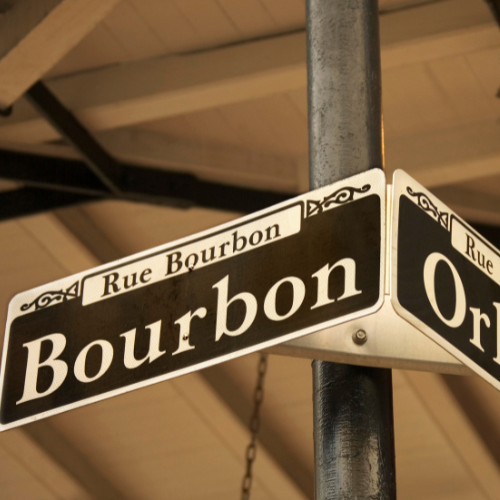 street sign that reads 'Rue Bourbon' in small text above larger text that reads 'Bourbon'